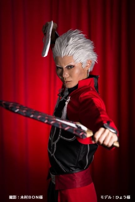 スタジオアンジュの赤の背景に構えのポーズをとるコスプレイヤー